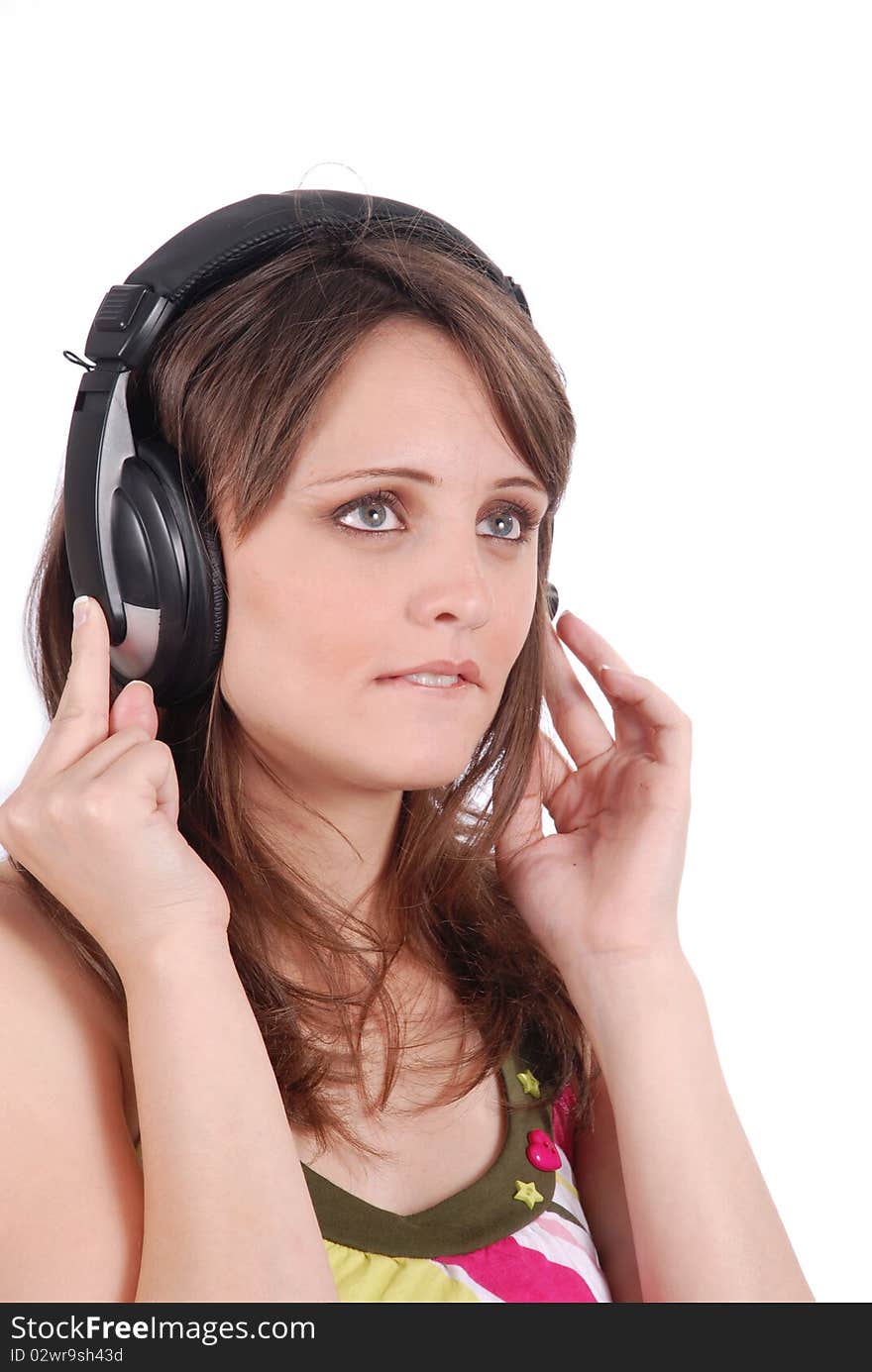 Girl listening to musicthrough headphones isolated on white.