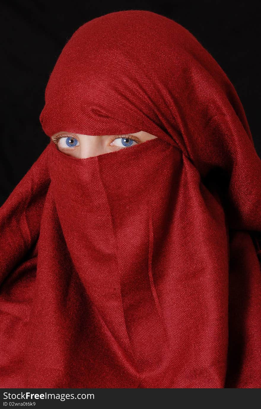 Slamic girl wearing a hijab against a black background. Slamic girl wearing a hijab against a black background.