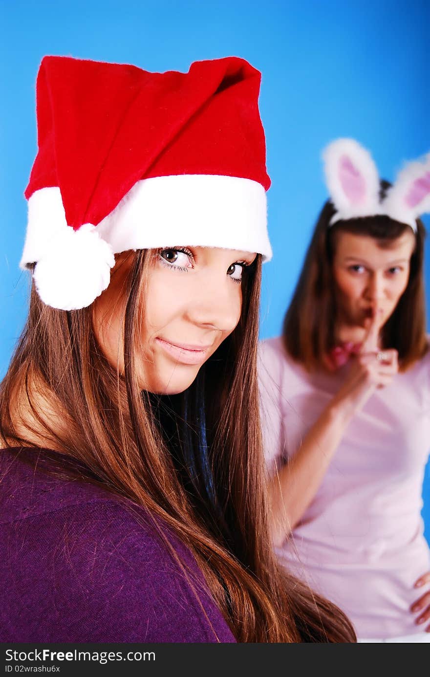 Two Christmas girls on a blue background. Two Christmas girls on a blue background.