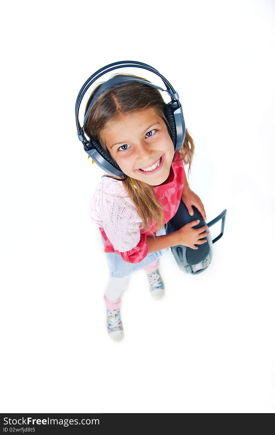 Cute pretty girl with headphones and a tape recorder is dancing. In the studio. Cute pretty girl with headphones and a tape recorder is dancing. In the studio