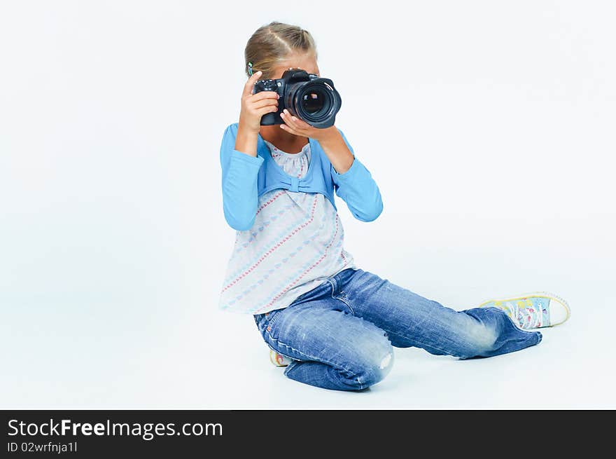 Pretty lovely girl with a camera big lens. In the studio