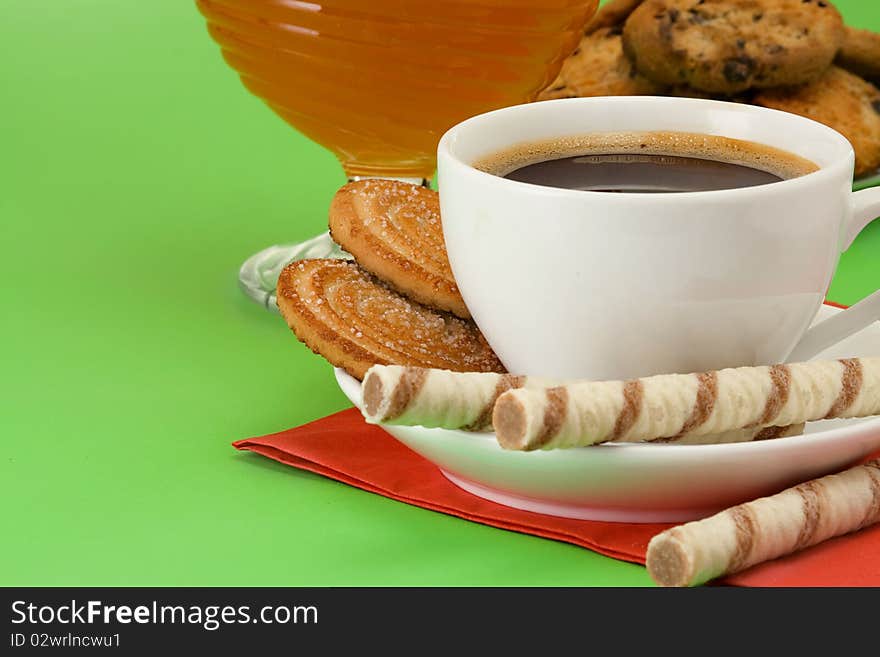 Coffee, honey and cookies on table