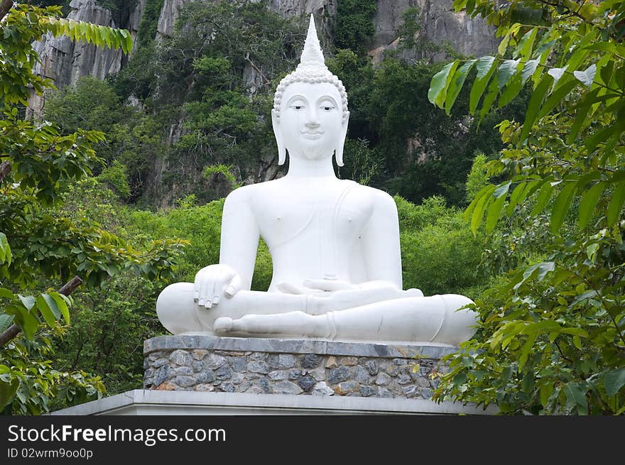 White statue buddha image on the mountain Thailand