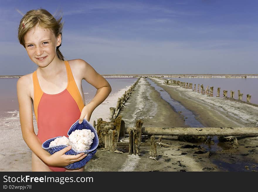 The girl on salty lake where extract salt