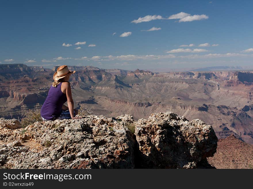 A woman staring on top of a mountain at the canyons in USA. A woman staring on top of a mountain at the canyons in USA