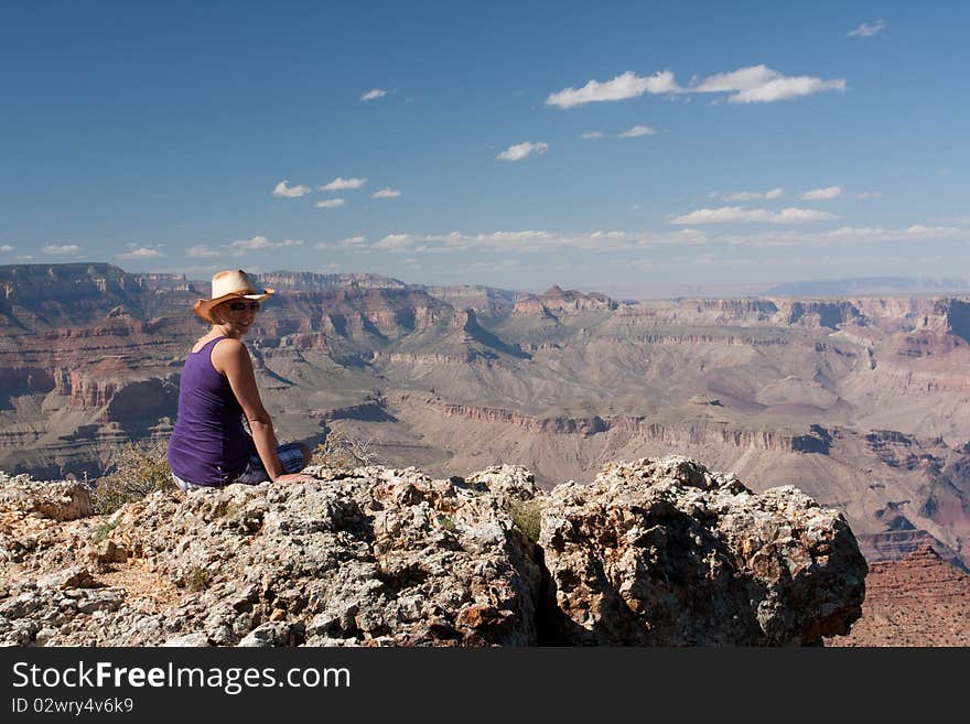 A woman posing on top of a mountain at the canyons in USA. A woman posing on top of a mountain at the canyons in USA