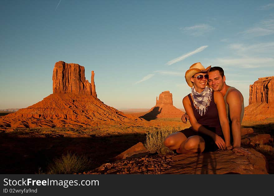 A portrait of a love couple laughing in front of a rock found in monument valley utah. A portrait of a love couple laughing in front of a rock found in monument valley utah