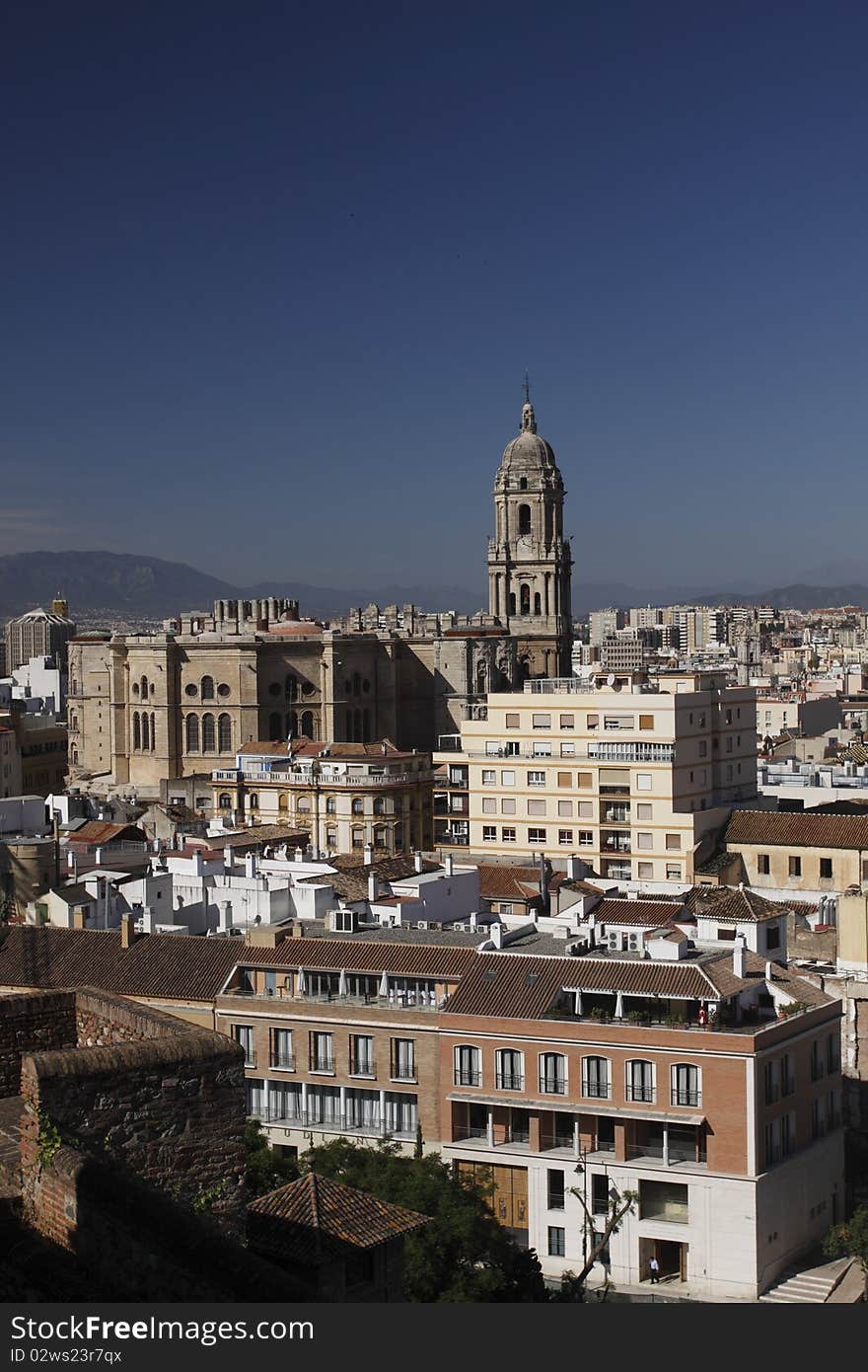 Málaga scenery represented by the tower of Málaga cathedral and the modern buildings.