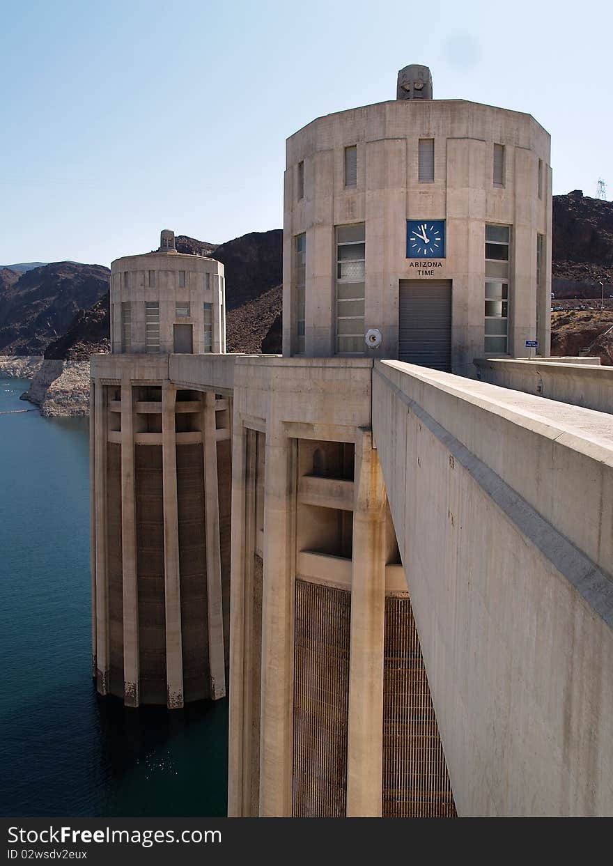 Hoover Dam's sculptured turrets, clock faces on the intake towers set for the time in Arizona. Hoover Dam's sculptured turrets, clock faces on the intake towers set for the time in Arizona.