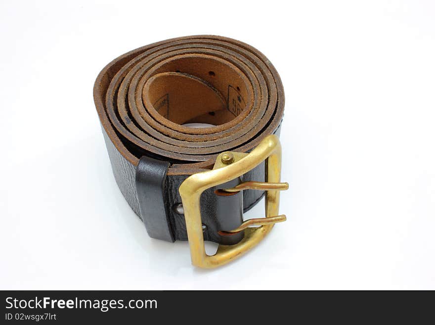 Brown officer belt braided in a roll as a roll with a metal metal plate.