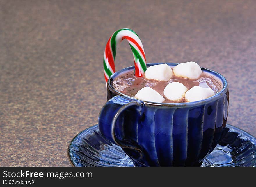 Christmas drink made with milk topped with mini marshmallows flavored with striped candy cane. Christmas drink made with milk topped with mini marshmallows flavored with striped candy cane