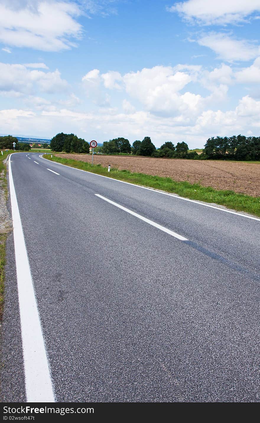 Straight asphalt road leading into the distance