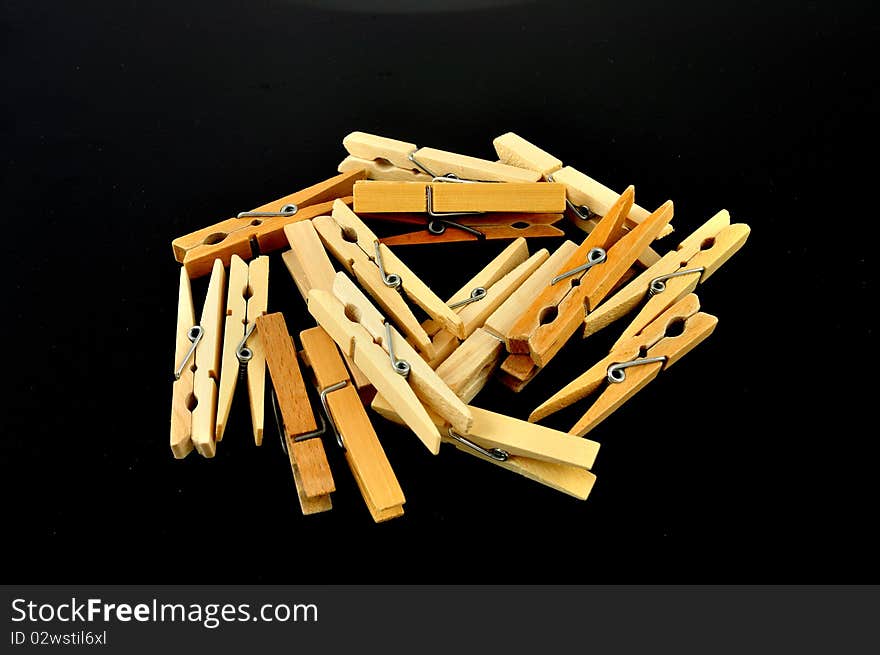 Wooden clothespeg isolated on a black background