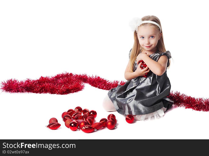 Smiling  little girl with red new year toys