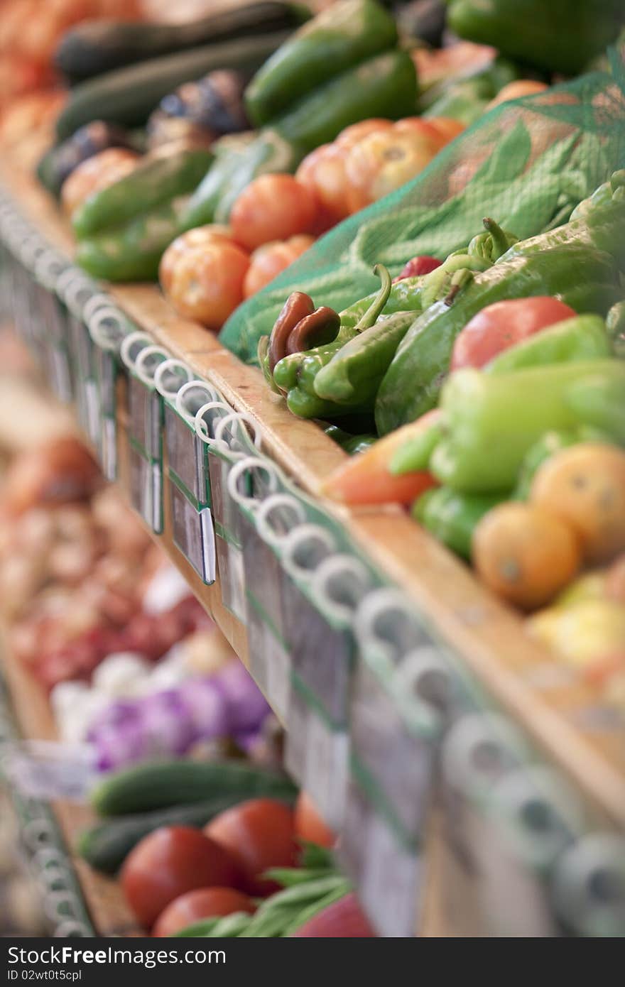 Mixed vegetables with selective focus on peppers in a supermarket stand. Mixed vegetables with selective focus on peppers in a supermarket stand