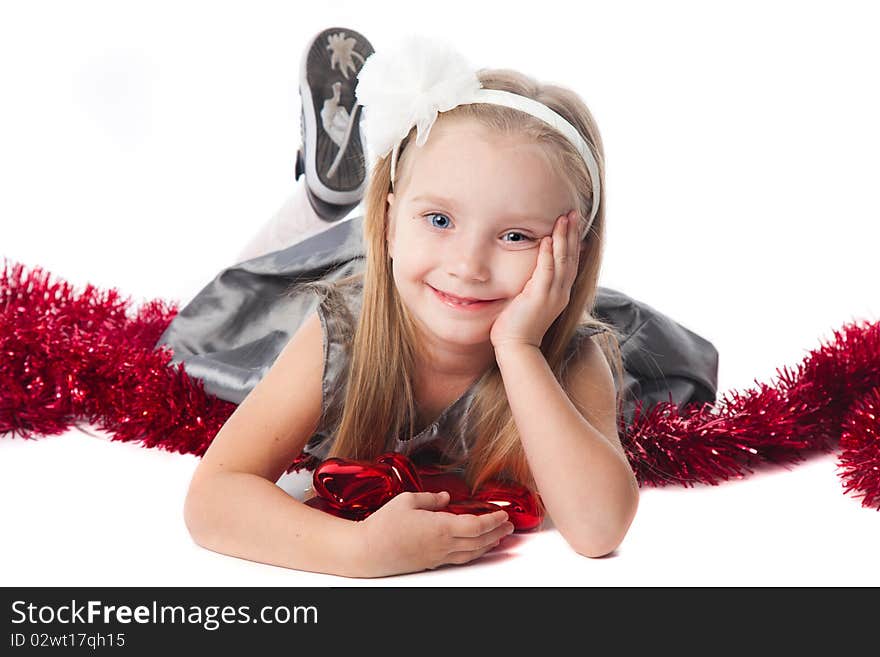 Smiling little girl with new year toys isolated