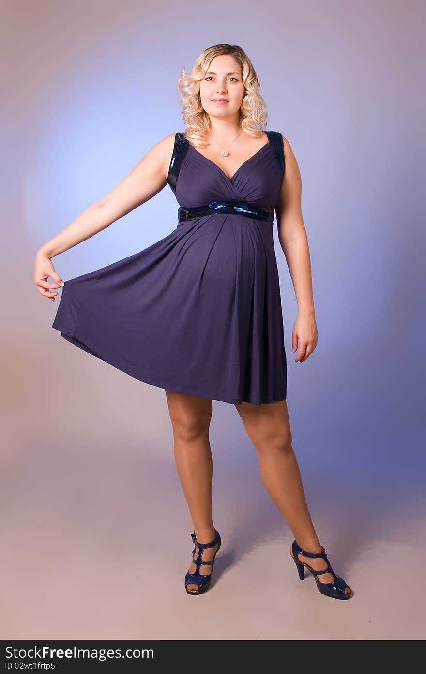 Photo of expectant mother in a dark blue dress