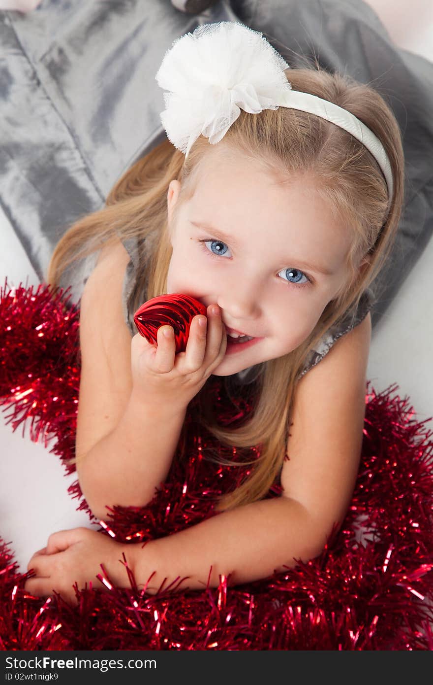 Smiling  little girl with new year toys