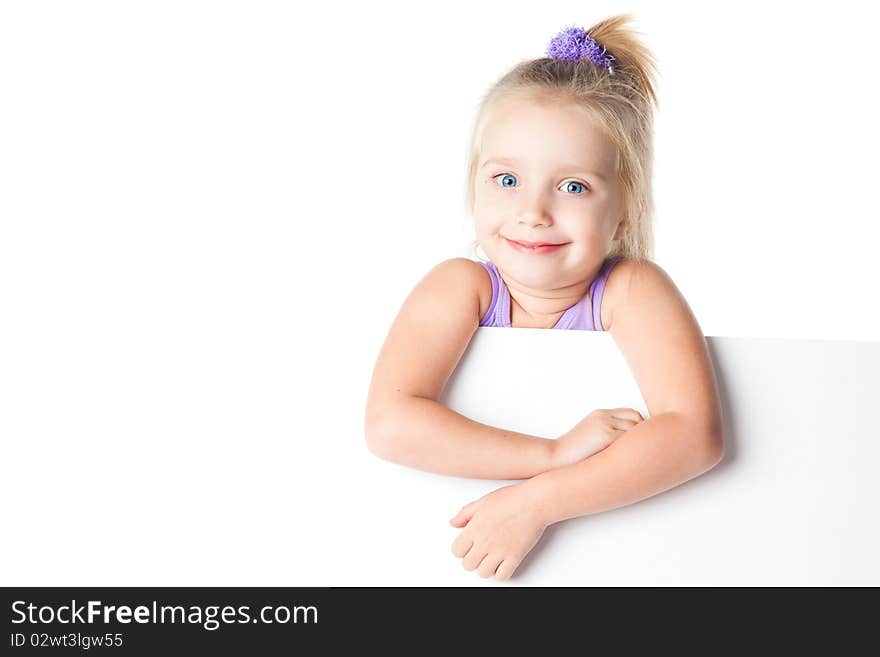 Surprised little girl looking over empty board isolated