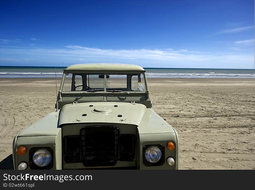 Four wheel drive vehicle on empty New Zealand beach. Four wheel drive vehicle on empty New Zealand beach