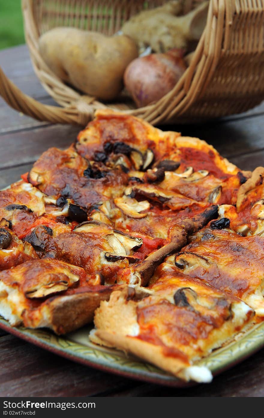 A slice of hot, fresh pizza being served,on wood table.