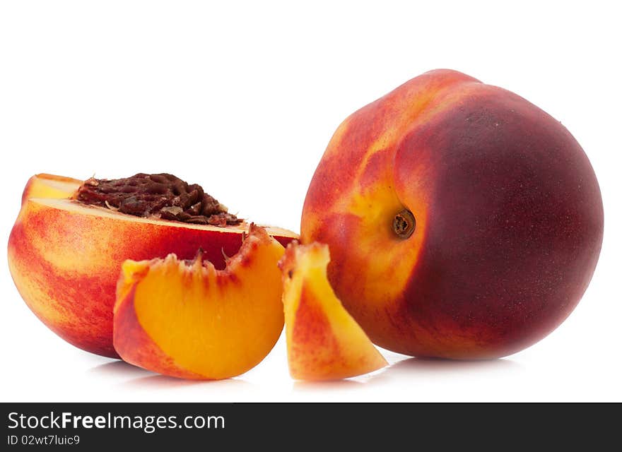 Tasty juicy peaches and slices of peaches on a white background