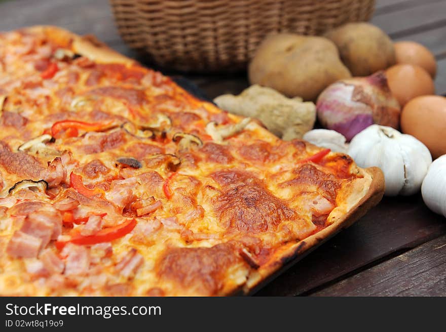 Close Up Of A slice of hot, fresh pizza being served,on wood table. Close Up Of A slice of hot, fresh pizza being served,on wood table.