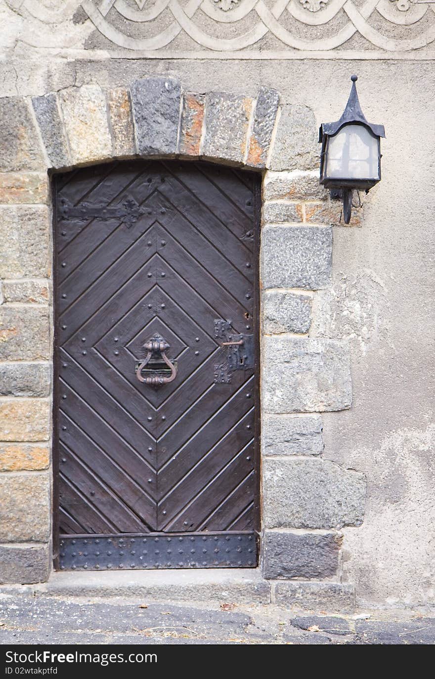 Old wooden medieval door with steel knocker. Old wooden medieval door with steel knocker