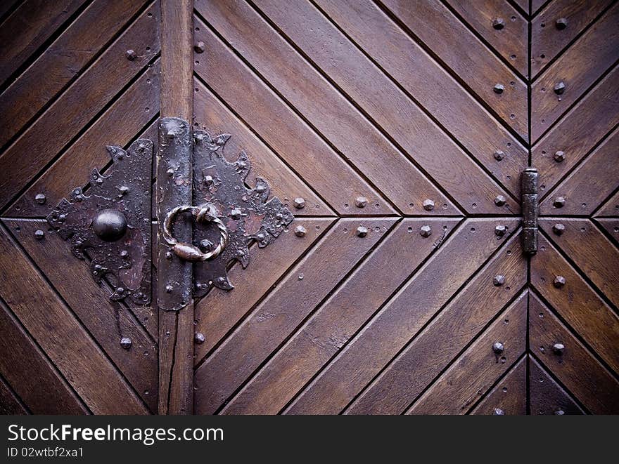 Steel medieval knocker on the old wooden historic door, hinge. Steel medieval knocker on the old wooden historic door, hinge