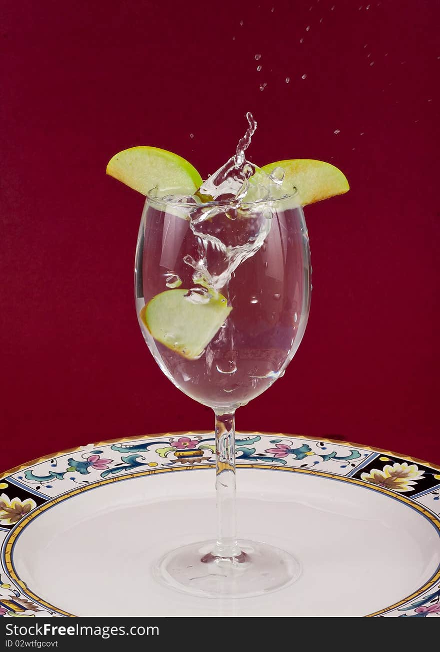 Apple Slice Splashing in Water On Plate