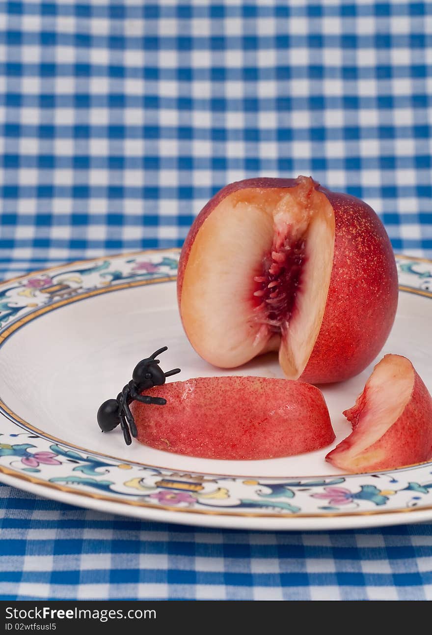 Fake Insect Eating a Slice of White Peach. Fake Insect Eating a Slice of White Peach