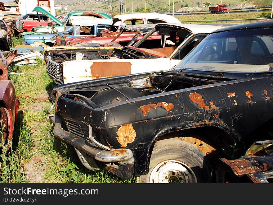 Old abandoned american cars in junkyard. Old abandoned american cars in junkyard.