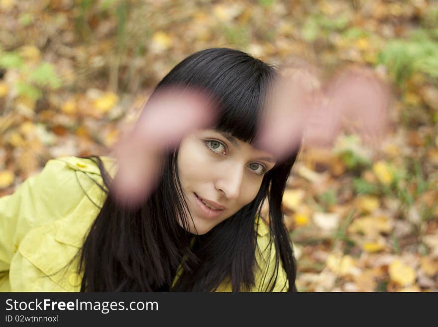 Young pretty woman on the autumn leaf.