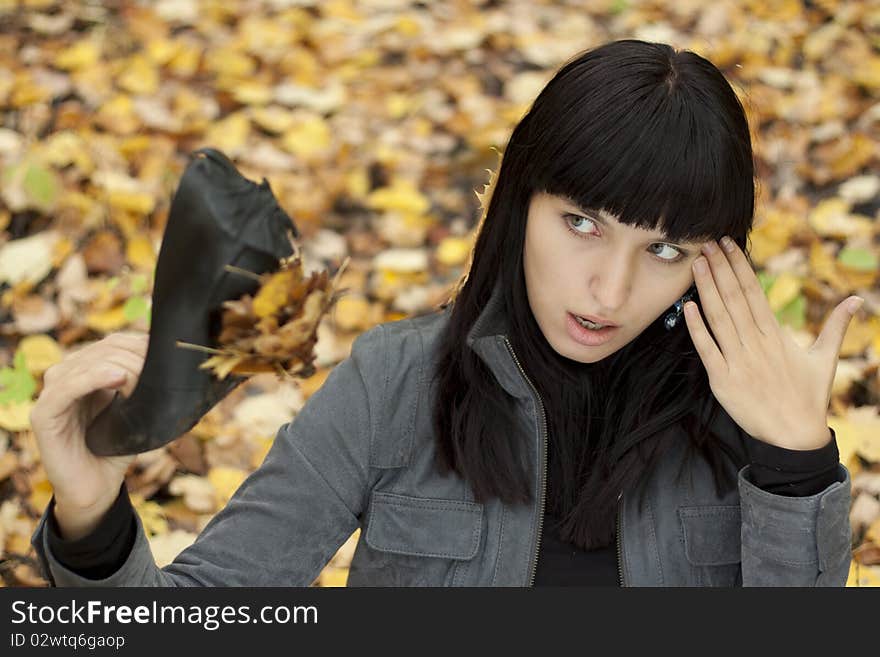 Young pretty woman on the autumn leaf