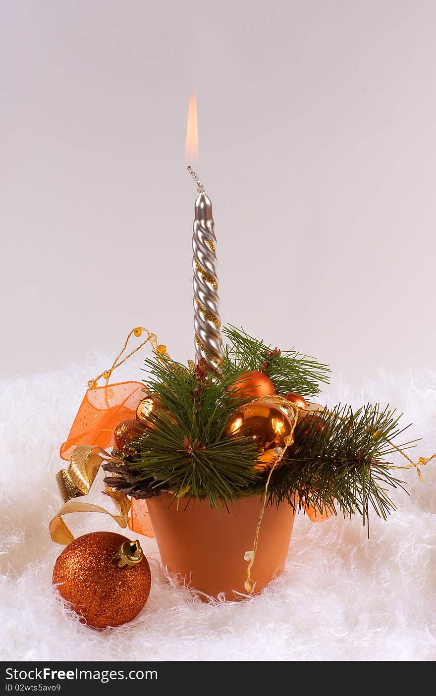 Christmas silver candles and red spheres on the white skin