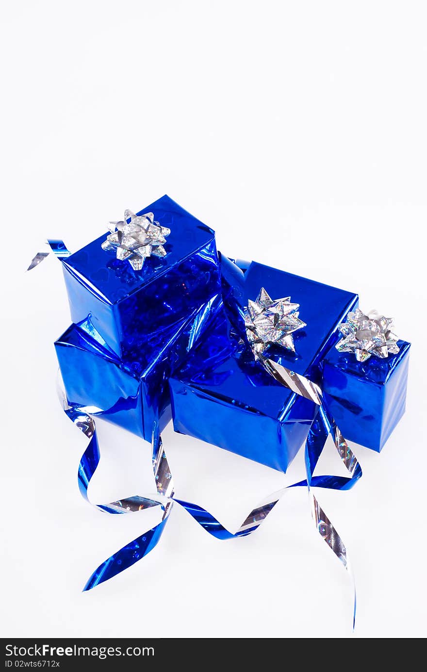 Many blue shiny boxes for gifts with ribbons and tapes