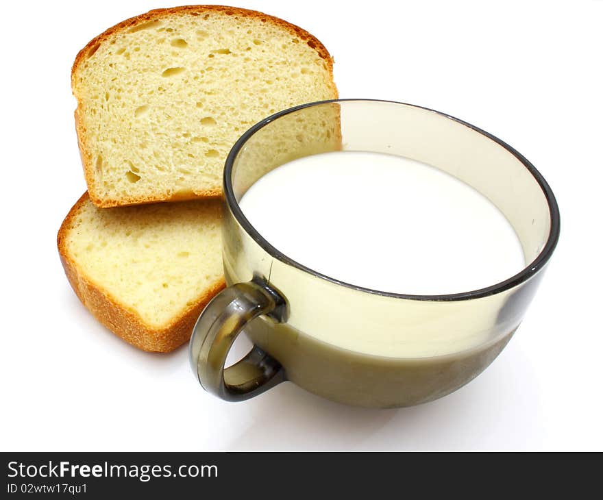 Black bread with milk in a mug on the white isolated background