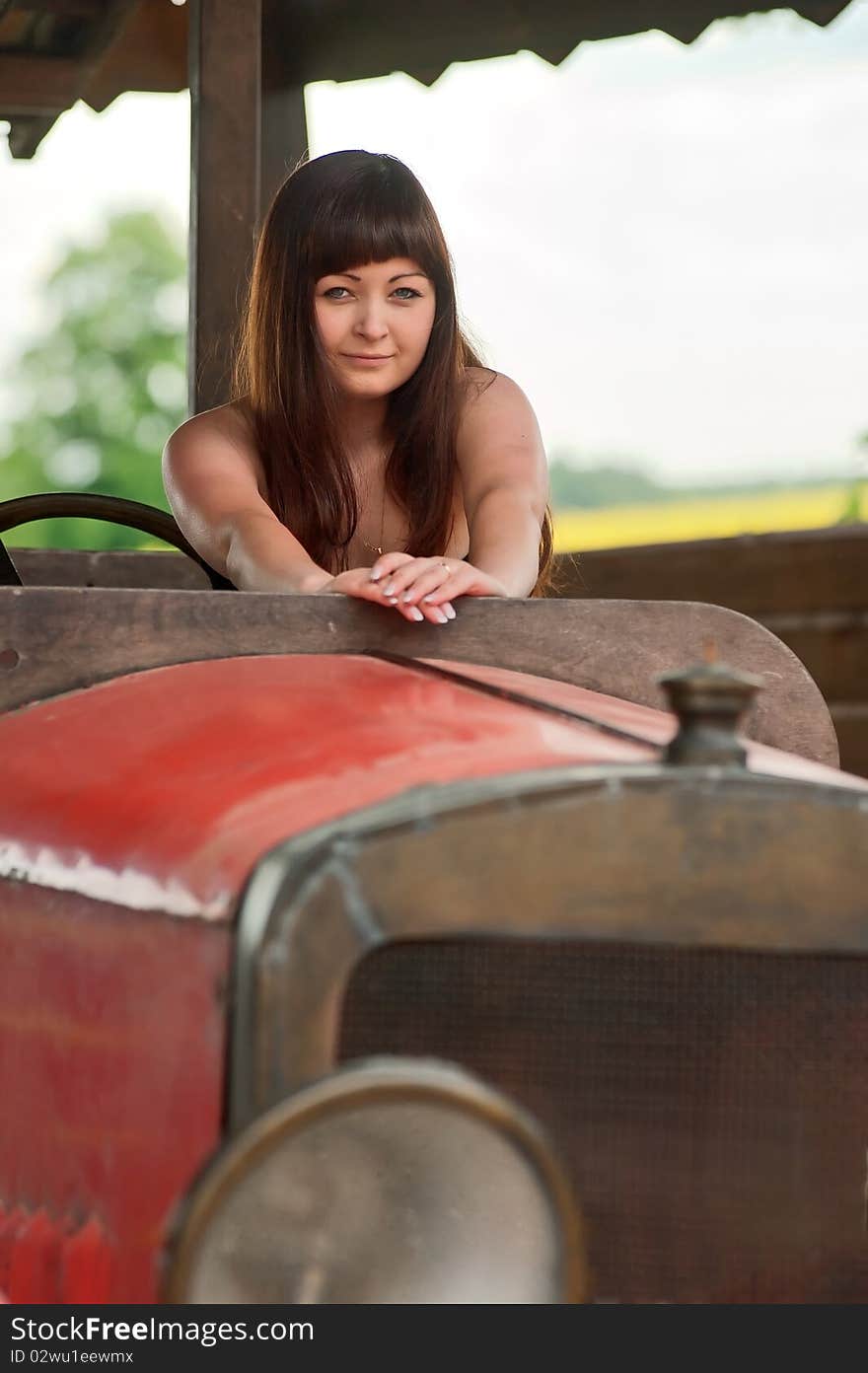 Young woman with old car.