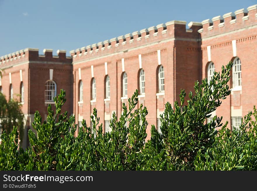 Green bushes in front of red brick fort Victoria on sunny day. Green bushes in front of red brick fort Victoria on sunny day