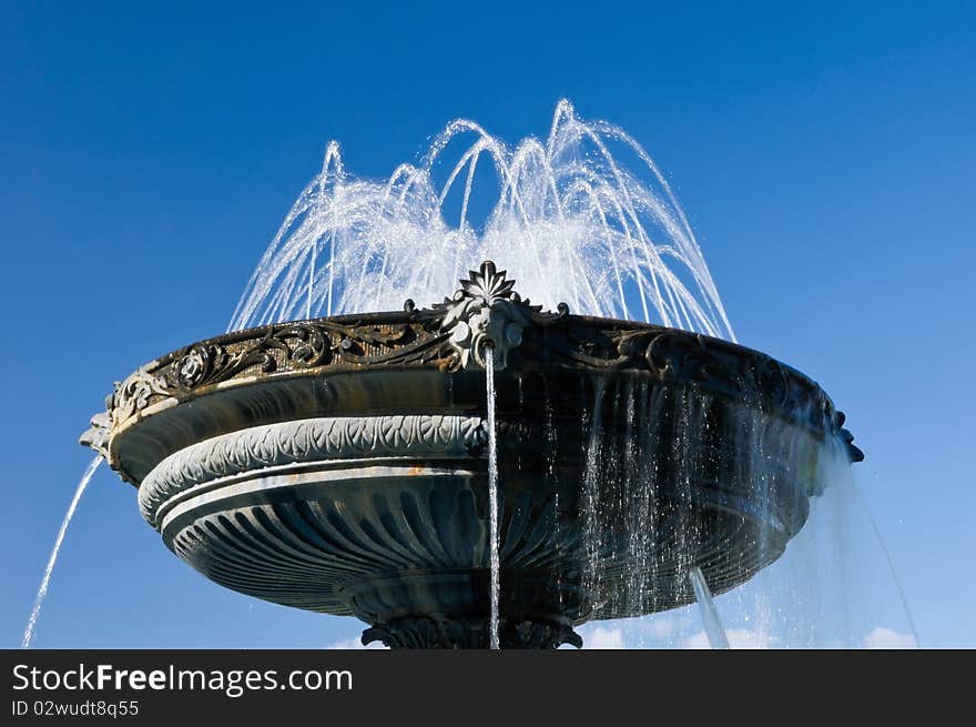 Fountain with historical design on blue sky