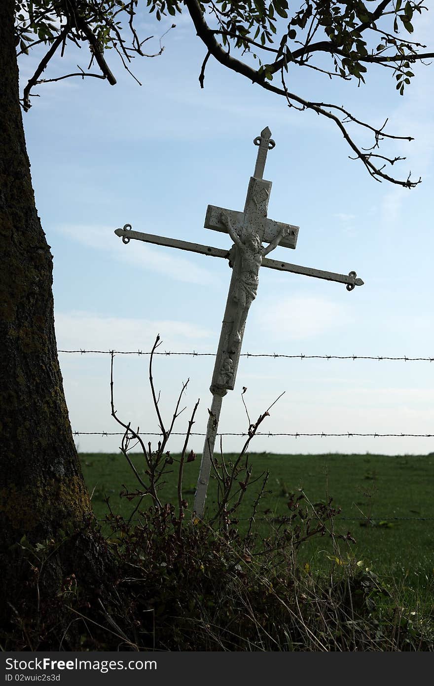 Wrought iron antique cross between the farmlands. Wrought iron antique cross between the farmlands.