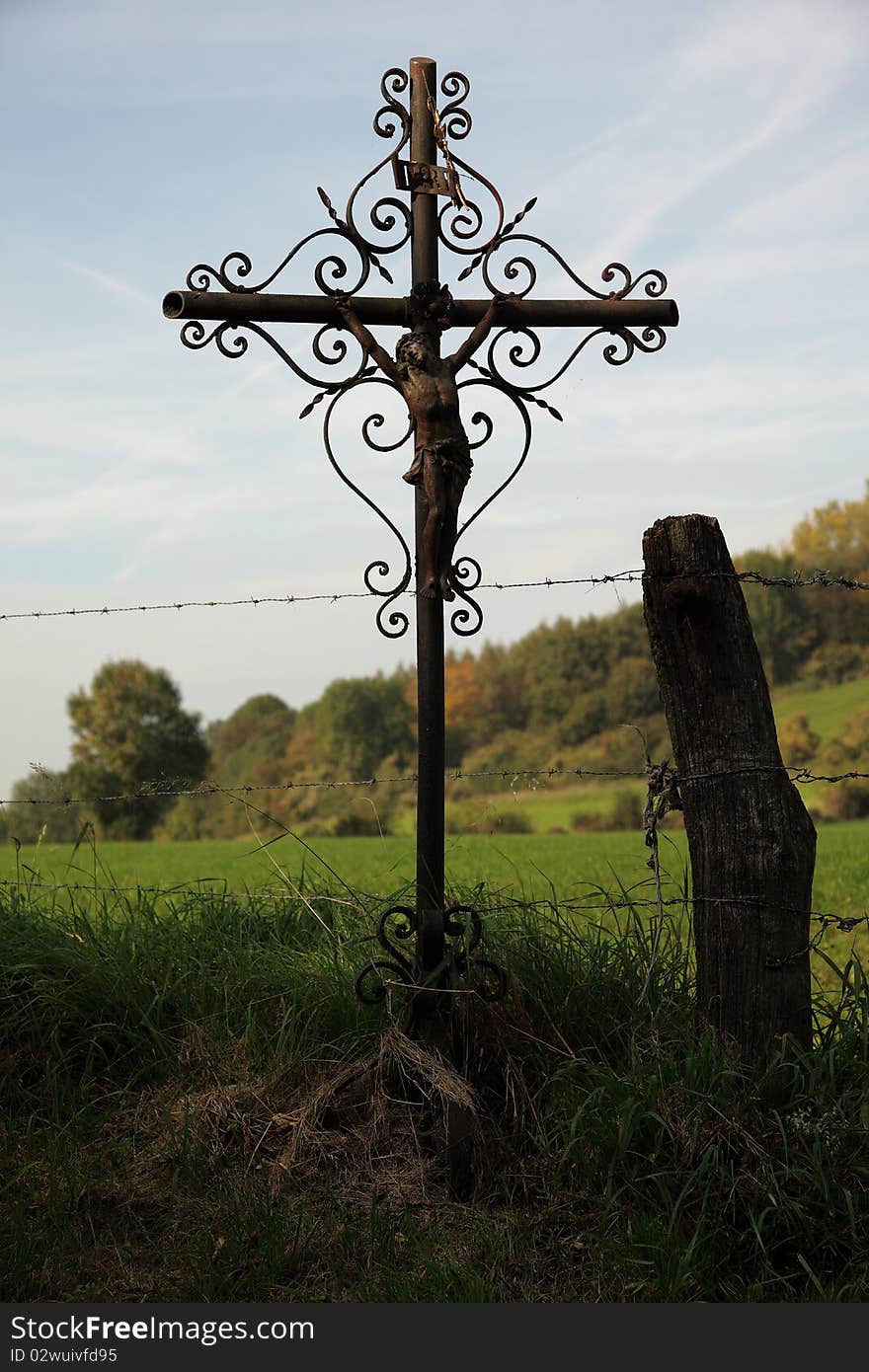 Wrought iron antique cross between the farmlands. Wrought iron antique cross between the farmlands.