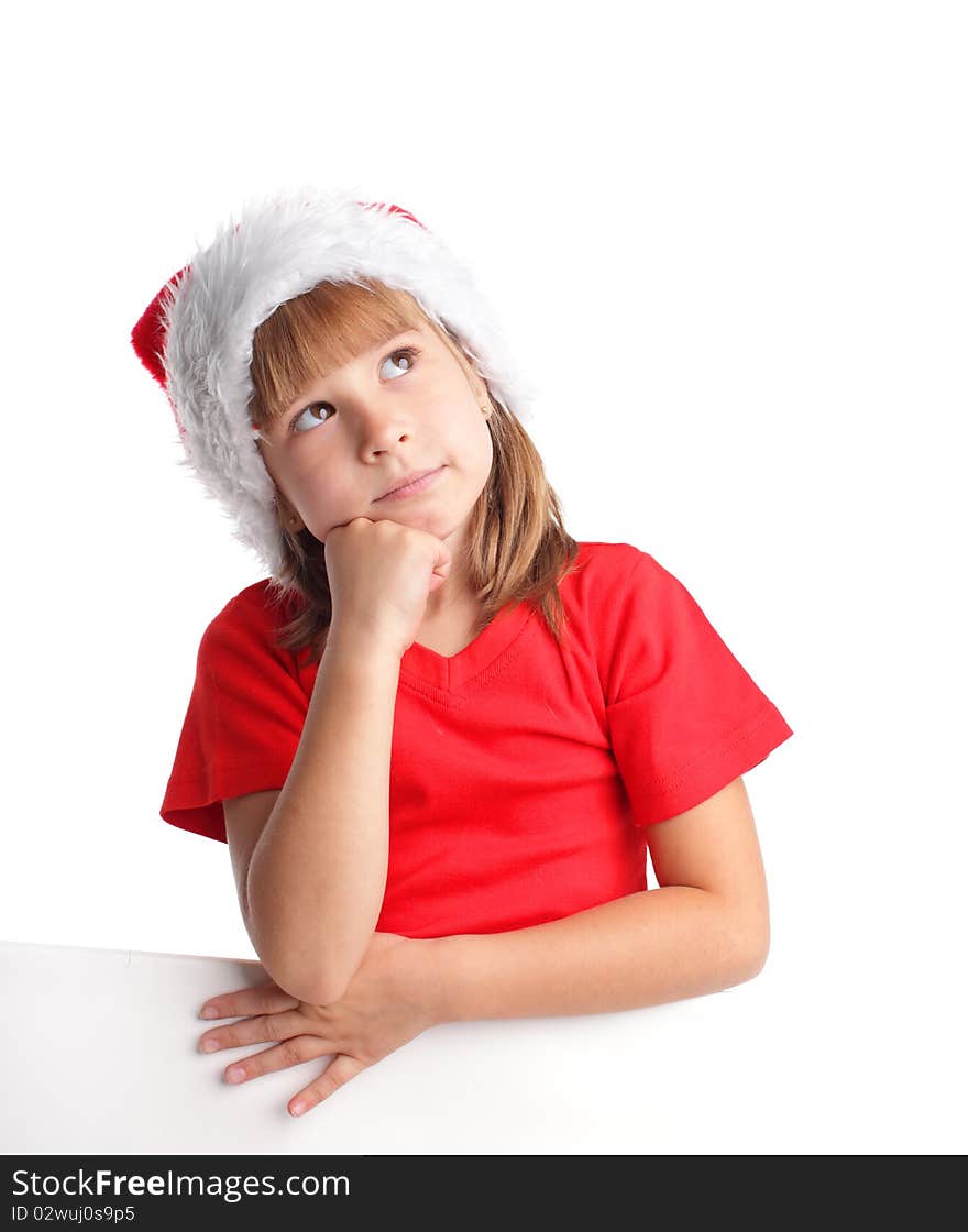 Little girl in christmas hat thinking