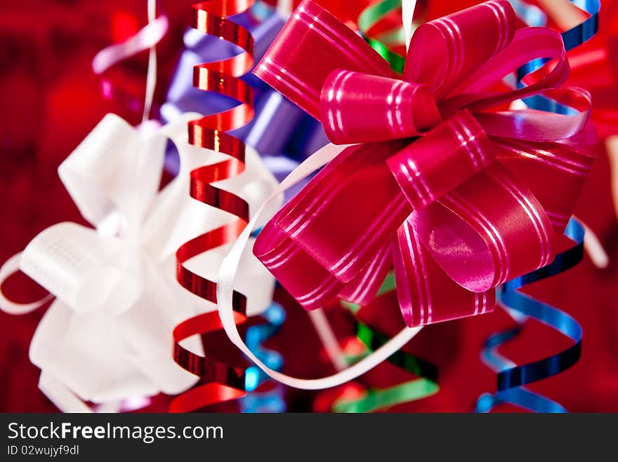 Beautiful christmas bows and ribbons on red background