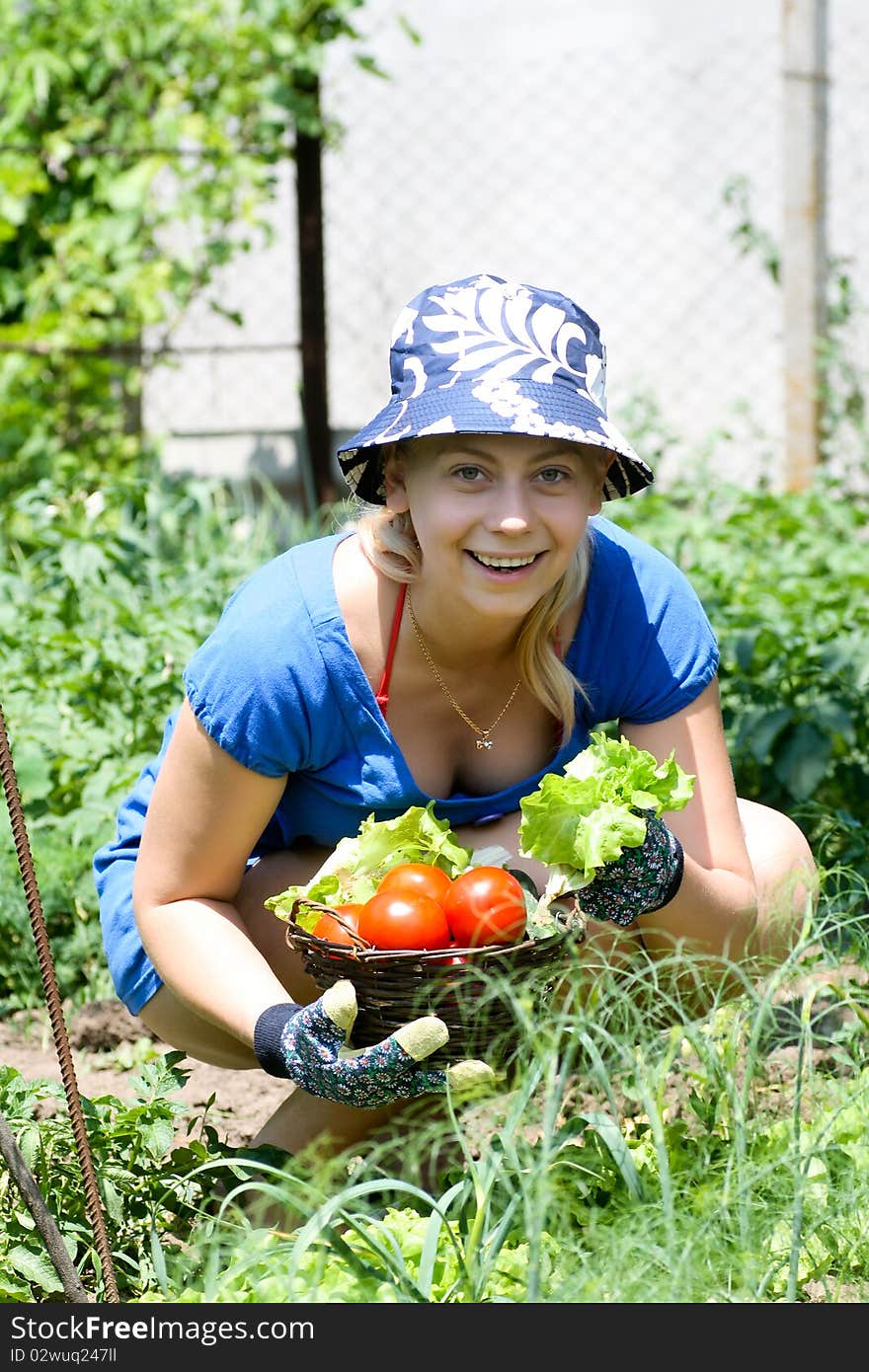 Young beautiful woman working in the garden