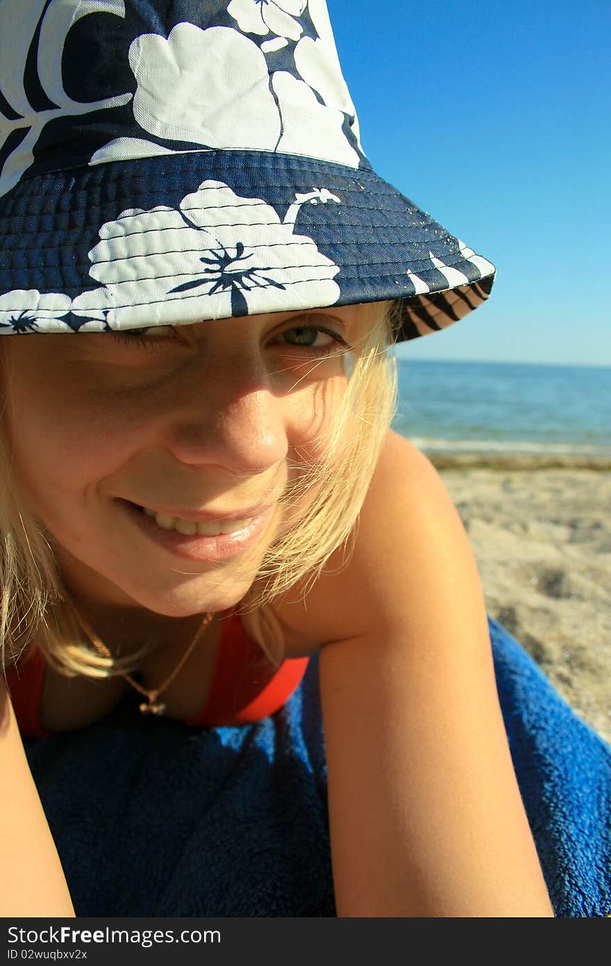 Young girl on the beach sitting and relaxing