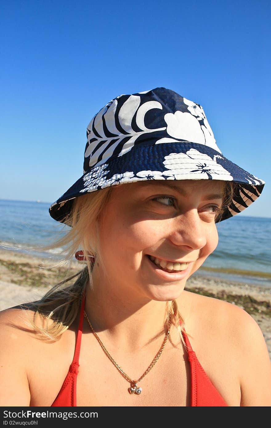 Young girl on the beach sitting and relaxing