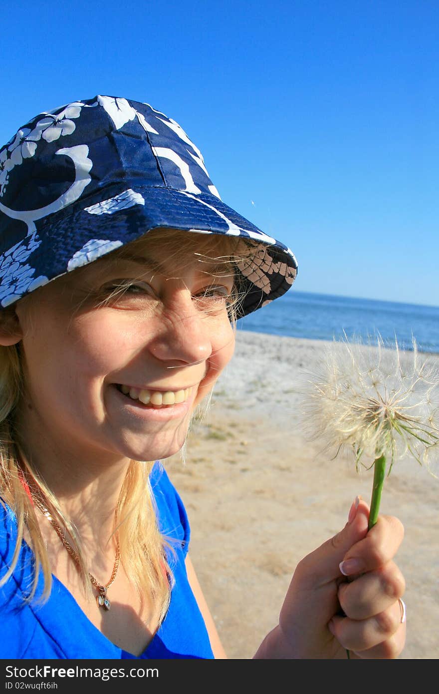 Woman blowing dandelion seeds