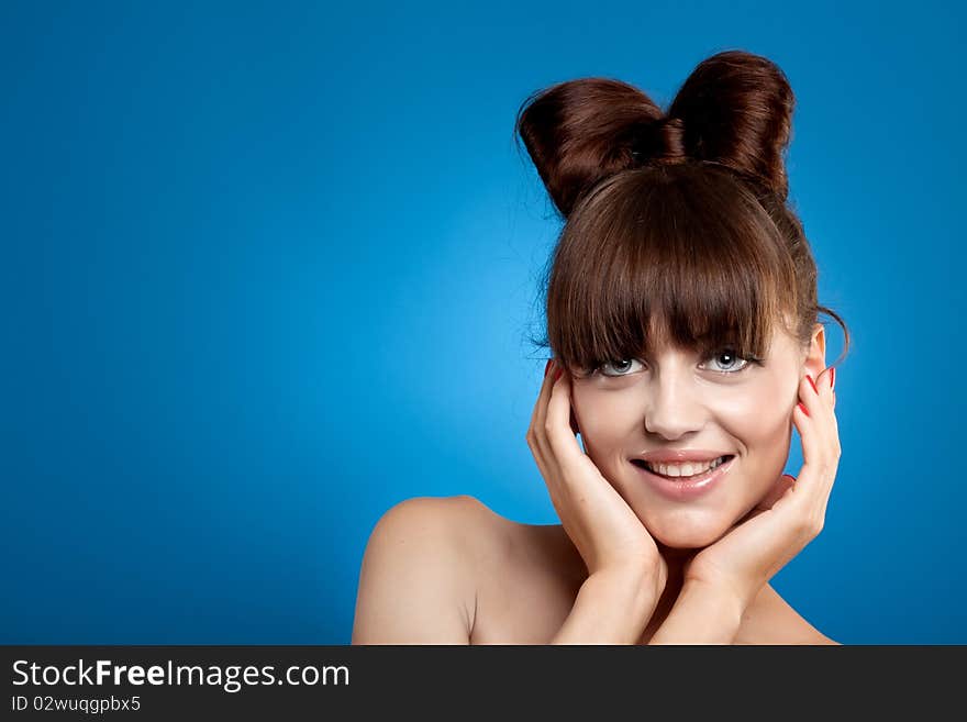 Studio portrait of attractive young woman on blue gradient background. Studio portrait of attractive young woman on blue gradient background