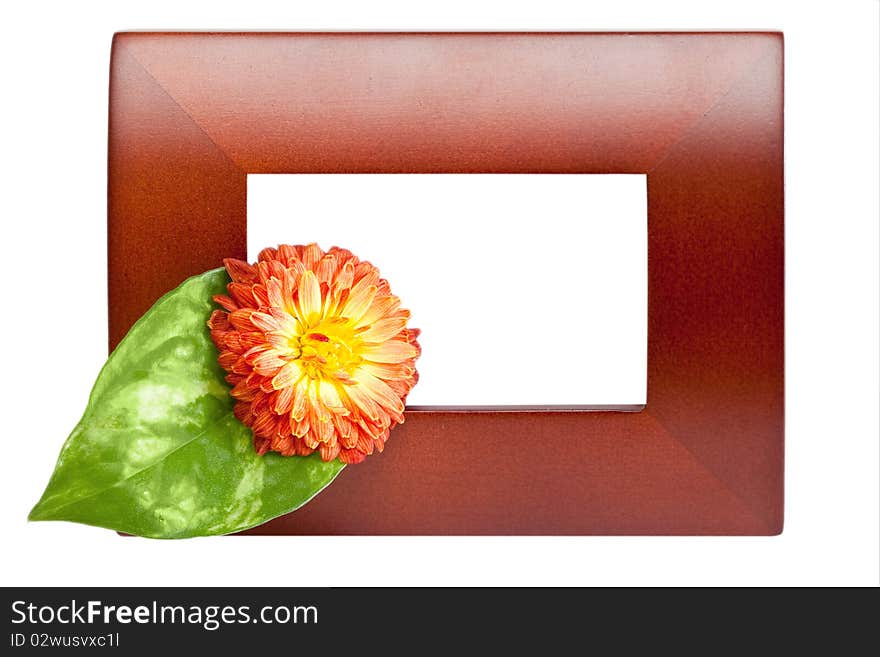 Empty wooden picture frame with flower on white background.